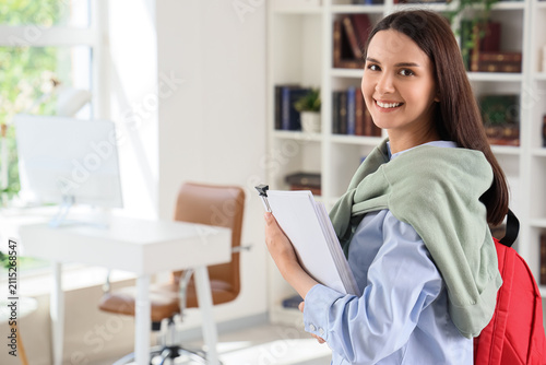 Smiling young woman holding...