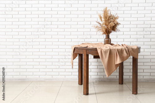 Wooden table with a beige t...