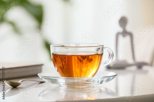 Glass cup of hot black tea ...