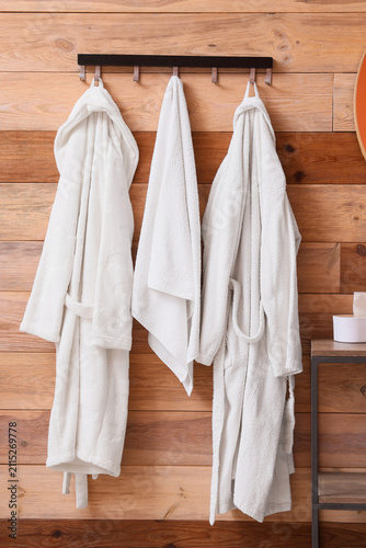 Rack with terry bathrobes a...