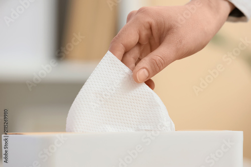 Female hand taking paper na...
