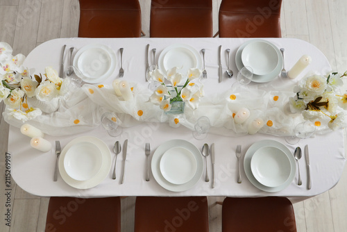 Canvas Print Elegant overhead view of a formal dining table set with white plates, silverware