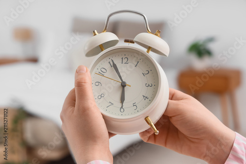 Female hands changing alarm...