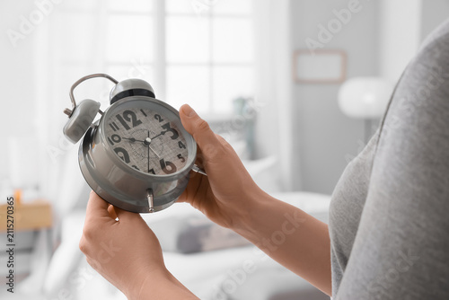 Woman setting time on alarm...