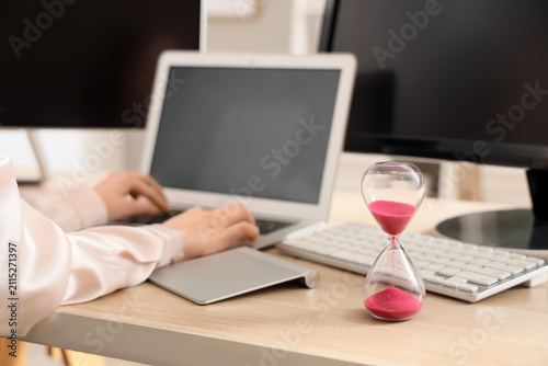 Hourglass on table of woman...