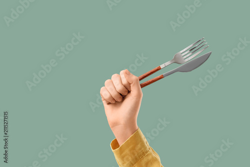 Human hand holding a fork a...