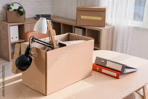 Desk with cardboard box in ...