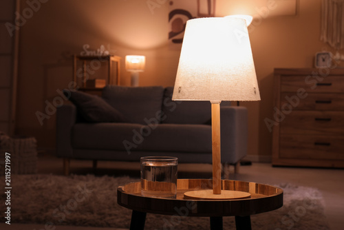 Glowing lamp and glass of w...