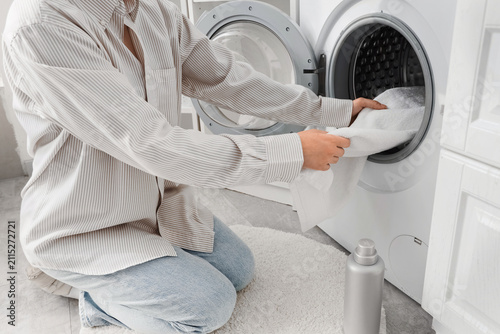 Woman putting towel into wa...