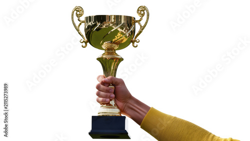Isolated hand holding a shiny golden trophy with ornate handles, symbolizing success and victory