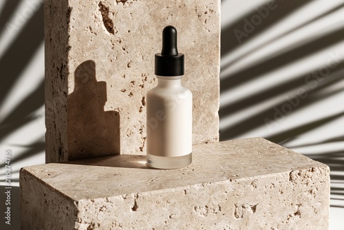 Matte glass skincare serum bottle on travertine stone block with tropical leaf shadows