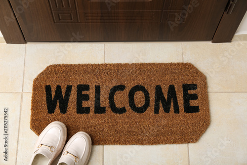Brown door mat and shoes on...
