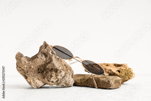 Stylish sunglasses and ston...