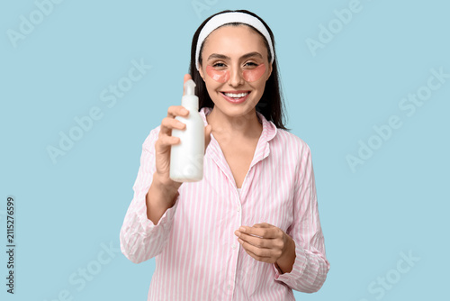 Young woman with bottle of ...