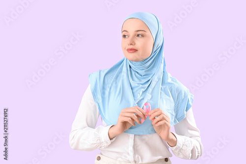 Young Muslim woman with pin...