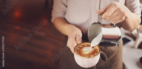Barista pouring steamed mil...