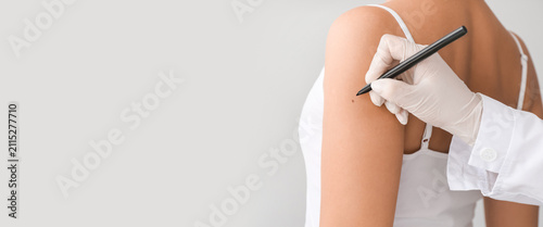 Dermatologist examining a m...