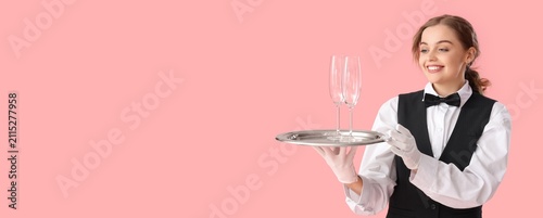 Smiling young waitress in u...