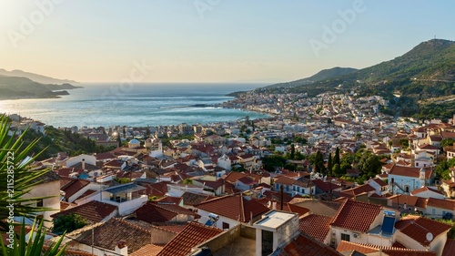 Obraz na płótnie Vathy, Greece - July 25, 2026: Panoramic view of Vathy from a hill on Samos Island, Greece, showing the coastal town, harbor bay, hillside houses, blue Aegean Sea water, and scenic island landscape