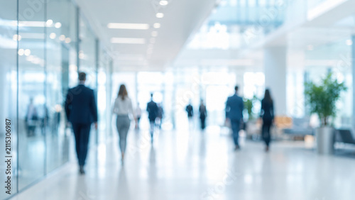 Bright modern blurred office interior background showing professional business people walking corporate workplace setting abstract contemporary room soft natural daylight bokeh