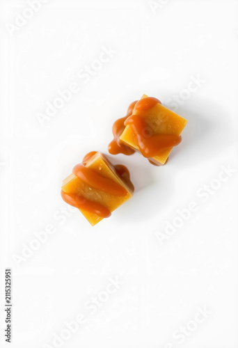 Two square caramel candies ...
