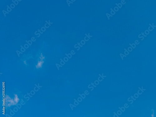  a clear blue sky with a few wispy, white clouds. Used as a clean canvas for digital wallpapers, graphic design, or presentation slides.