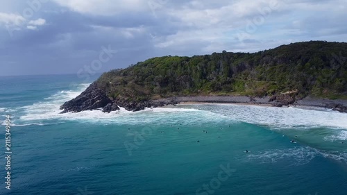 Surfers along Noosa National Park coastline