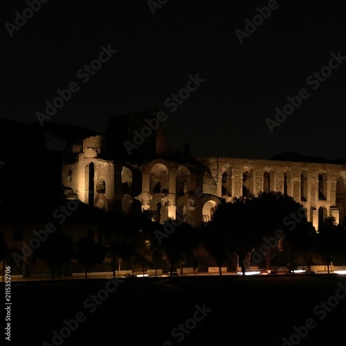 Fotografie The Outside of the Roman Forum Ruins from the Circus Maximus at Night