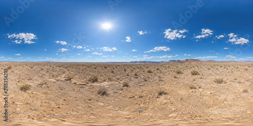 HDRI Clear Noon Desert Lighting Map 360 Panoramic view of a clean rocky plateau with pale ground, distant ridges, a brilliant blue sky, small clouds, and sharp midday shadows