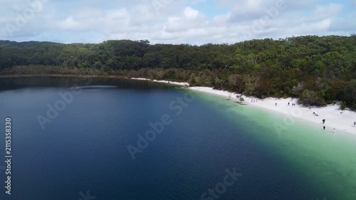 Blue lake and sandy shore on K'gari from above