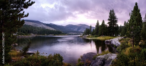 Serene Lake Landscape with Mountains and Cloudy Sky.