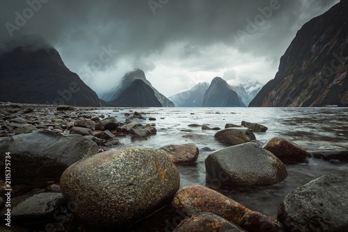 Dramatic Milford Sound Landscape with Rocks and Overcast Sky.
