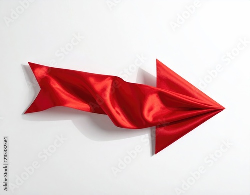 A flowing red satin ribbon forms an arrow shape, pointing right, on a white background