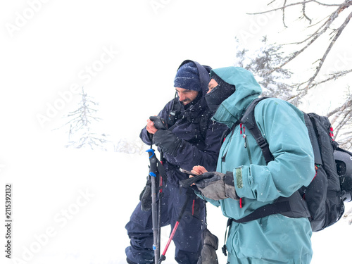 Obraz na płótnie People navigating winter backcountry in whiteout conditions in Hokkaido