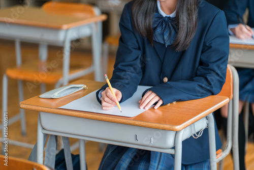 Fotografie Middle school and high school girls taking tests in school classrooms or cram school classes