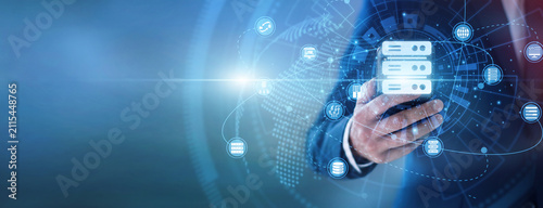 Canvas Print IT technician using hand hold mobile to monitor web Hosting server networks