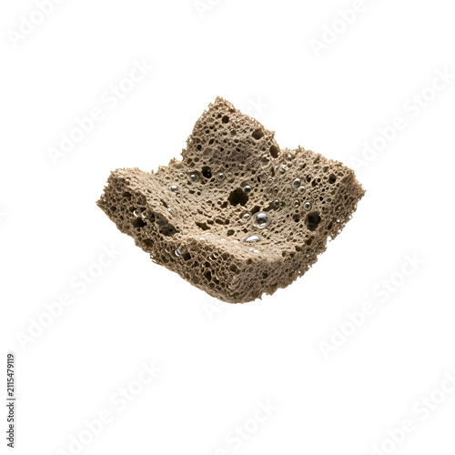 Macro view of brown porous sponge with metallic silver droplets isolated on transparent background