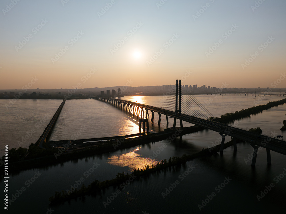 Fototapeta premium Cable stayed bridge over St Lawrence River at golden sunrise near Montreal and Brossard, Canada. g.