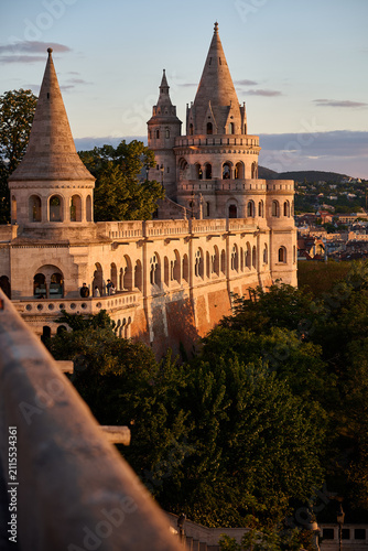 Wide view of Fisherman's Bastion stone fortress and towers bathed in sunset light in Budapest, Hungary, Europe