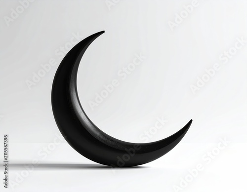 A stark black crescent moon rests against a white background, casting a subtle shadow
