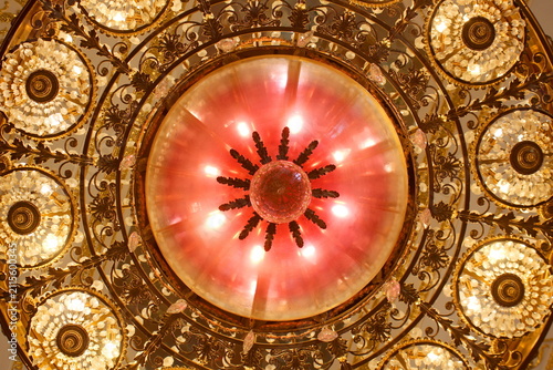 Fotografie A beautiful historic chandelier hangs from the ceiling in an ancient castle