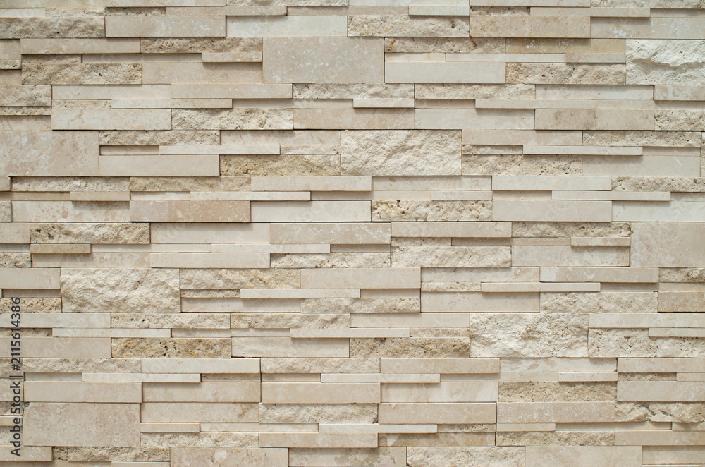 Fototapeta premium Modern relief decorative stacked stone wall cladding texture in beige tone