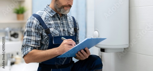 Home Maintenance Service with Professional Man in Uniform Taking Notes on Clipboard