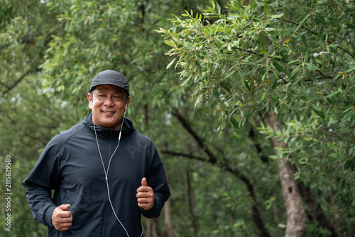 Senior old man runner exercise outdoor nature park. fitness man jogging wearing sportswear. Mature athlete man in sportswear Workout running at public park. Health and activity old man lifestyle