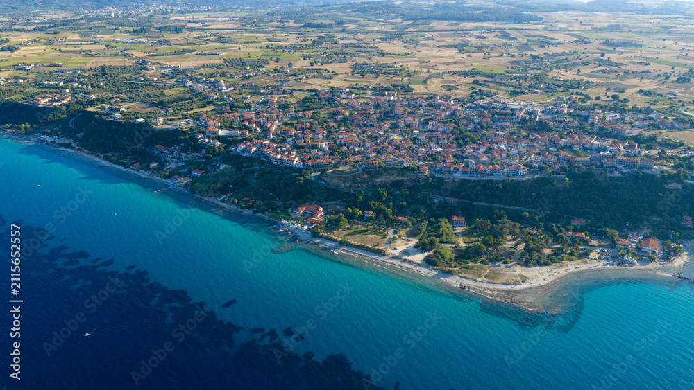 Obraz premium Aerial view of coastal town with blue sea and shoreline