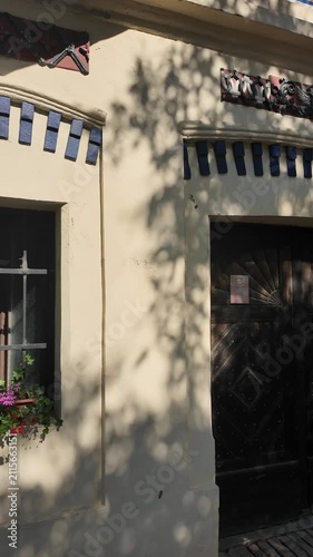 Charming European building facade with wooden doors and flower boxes