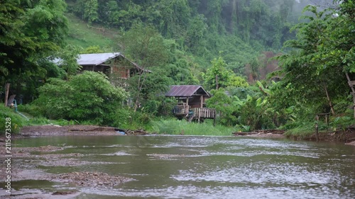River flowing through rural village in the forest