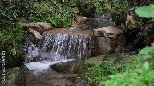 River flowing through the waterfall in the forest