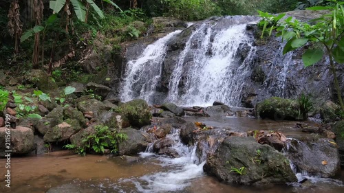 River flowing through the waterfall in the forest