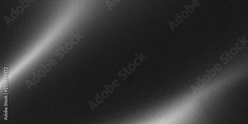 Textured dark metal surface with diagonal bright light reflections and subtle grain for abstract backgrounds